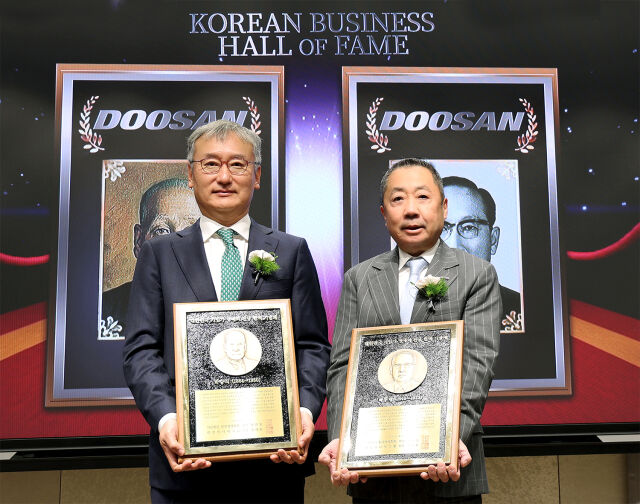 24일 서울 이화여대 경영대학 60주년 기념홀에서 열린 ‘대한민국 기업가 명예의 전당’ 헌액식에서 박정원 두산그룹 회장(오른쪽)이 헌액 기념패를 들고 양희동 한국경영학회 회장(왼쪽)과 함께 기념촬영을 하고 있다. /두산그룹