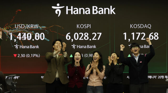 코스피가 장중 6000을 넘은 25일 오전 서울 중구 하나은행 딜링룸에서 관계자들이 코스피 6000 돌파를 축하하고 있다. /뉴시스
