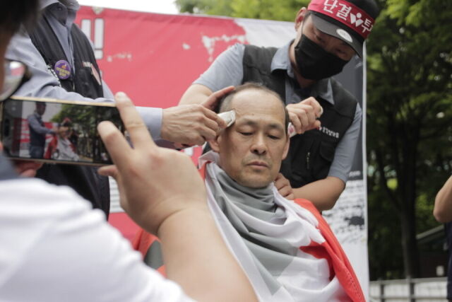 임기홍 화섬식품노조 오리온지회장이 지난달 26일 서울 용산 오리온 본사 앞에서 열린 화섬식품노조 오리온지회 총파업 출정식에서 삭발을 하고 있다. /화섬식품노조