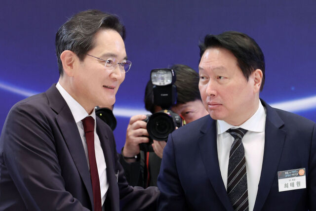 이재용(왼쪽) 삼성전자 회장과 최태원 SK회장이 지난 6월 29일 청와대 영빈관에서 열린 ‘대한민국 대도약 3대 메가프로젝트 국민보고회’에서 악수하고 있는 모습. /뉴시스